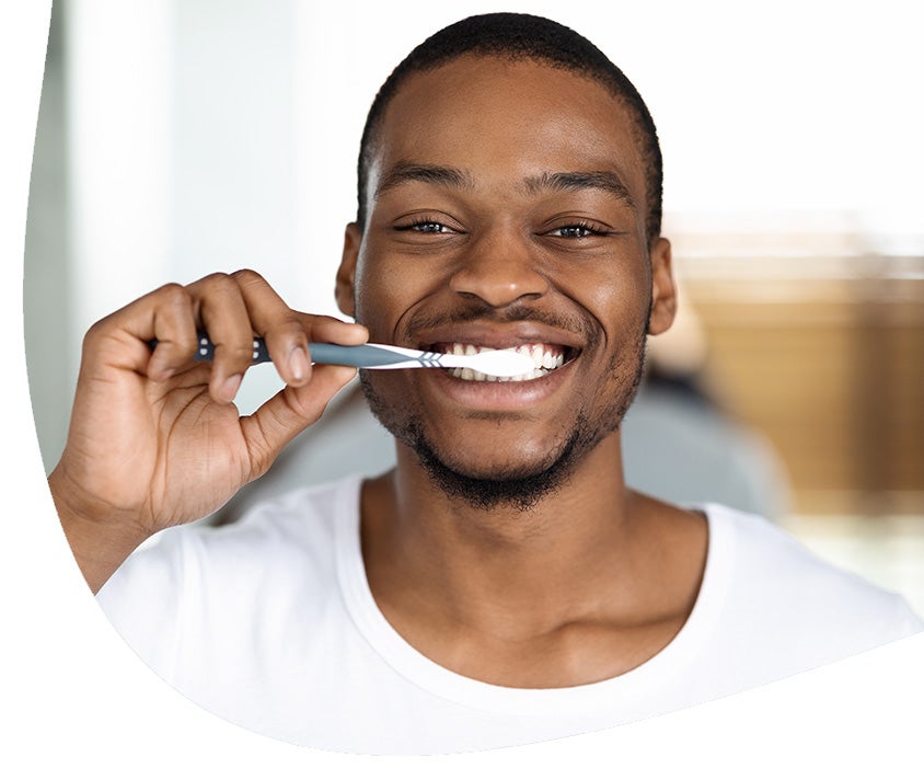 A man practicing his oral care routine to ensure healthy gums